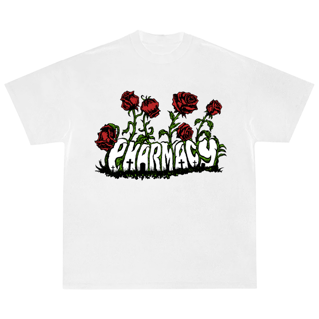 A white short-sleeve crewneck t-shirt featuring a graphic print of red roses with green stems and thorns rising above the word 'PHARMACY' in a stylized white font with black outlines.