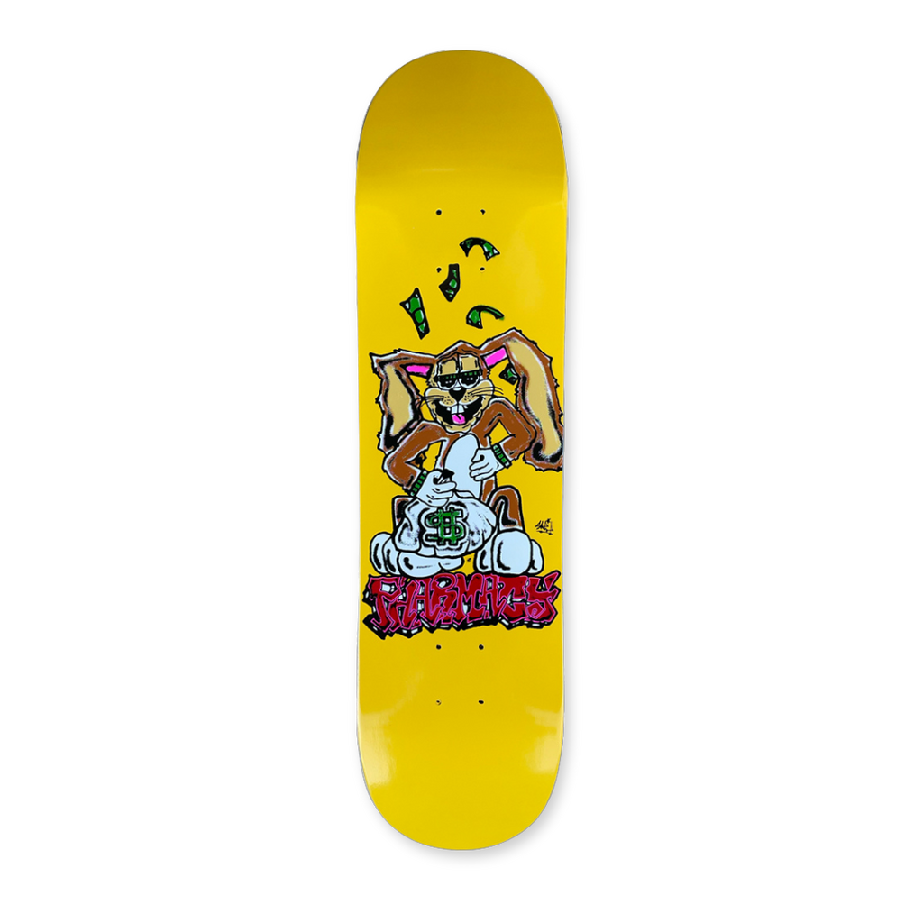 Yellow skateboard deck with cartoon bunny character. Red Pharmacy graffiti style text below.
