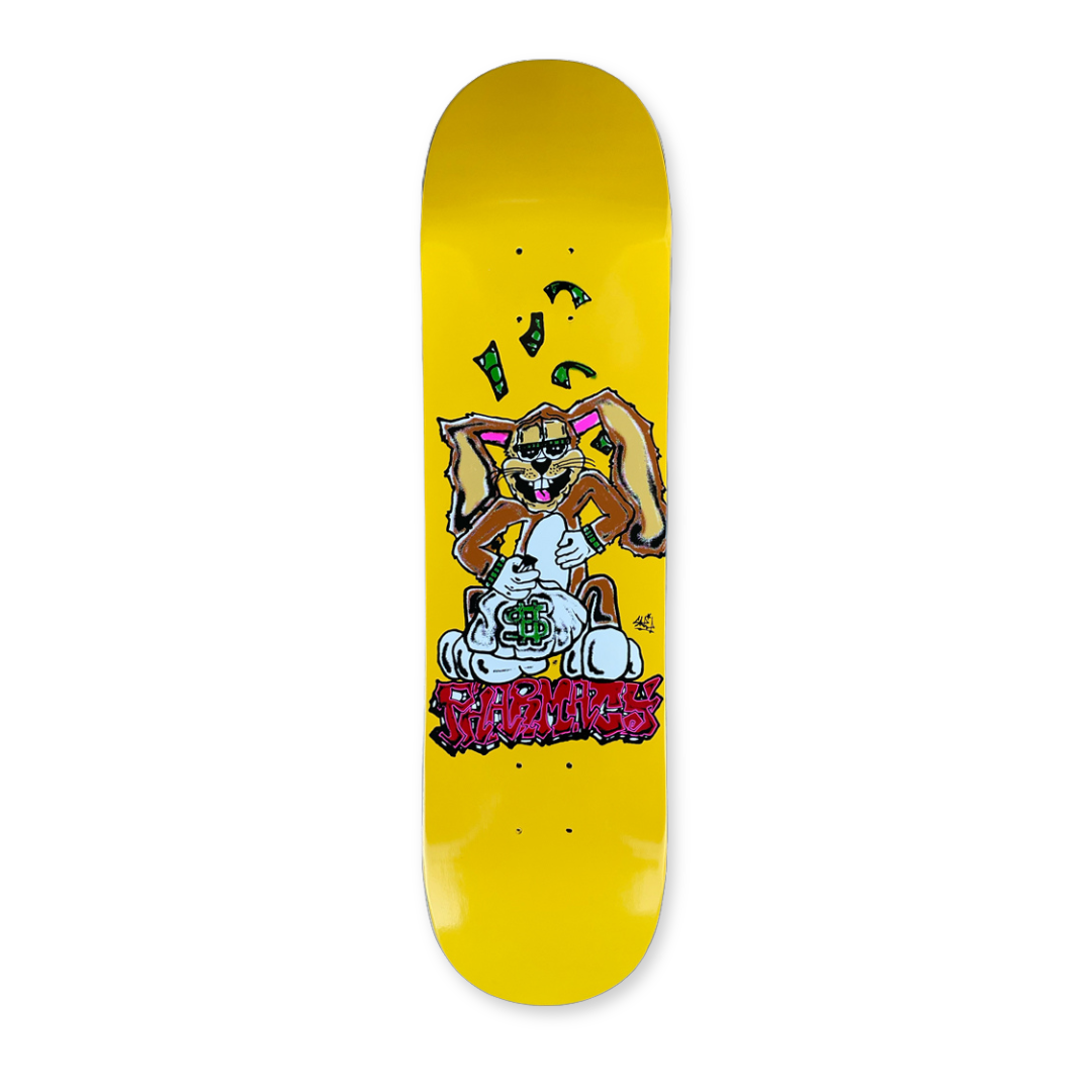 Yellow skateboard deck with cartoon bunny character. Red Pharmacy graffiti style text below.
