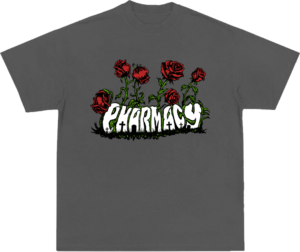 A dark gray short-sleeve t-shirt with a graphic on the chest featuring red roses and the word 'PHARMACY' in a white, distressed font over a black grass-like base.